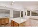 Kitchen featuring an island, tile flooring, and lots of natural light at 7929 W Wescott Dr, Glendale, AZ 85308