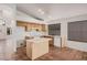 Kitchen featuring an island, tile flooring, and white appliances at 7929 W Wescott Dr, Glendale, AZ 85308