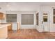 Bright kitchen with light wood cabinets, a white dishwasher, red-tiled floor, and exterior access at 7929 W Wescott Dr, Glendale, AZ 85308