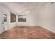 Spacious room featuring high ceilings, neutral paint, red-tiled flooring, and a fan at 7929 W Wescott Dr, Glendale, AZ 85308