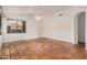 Room featuring high ceilings, neutral paint, red-tiled flooring, a fan, and window at 7929 W Wescott Dr, Glendale, AZ 85308