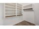 Bright walk-in closet with white shelving and carpeted floor at 7929 W Wescott Dr, Glendale, AZ 85308