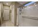 Bright bathroom showing a large seamless glass enclosed shower with tiled walls and floor at 9547 W Chama Dr, Peoria, AZ 85383