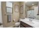 Charming bathroom featuring framed signs, a toilet, sink, and shower with a curtain at 9547 W Chama Dr, Peoria, AZ 85383