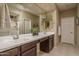 Bathroom featuring a double sink vanity, a large mirror, and a shower/tub combination at 9547 W Chama Dr, Peoria, AZ 85383