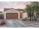 Charming single-story home with a two-car garage, desert landscaping and a tile roof at 9547 W Chama Dr, Peoria, AZ 85383