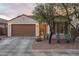 Charming single-story home showcasing a desert landscape, two-car garage, and inviting front entrance at 9547 W Chama Dr, Peoria, AZ 85383