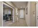 Hallway with tile flooring leading to the front door and an adjacent office space at 9547 W Chama Dr, Peoria, AZ 85383