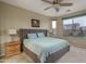 Serene bedroom with carpet flooring, ceiling fan, and natural light at 9547 W Chama Dr, Peoria, AZ 85383