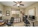 Home office featuring two workstations, natural light, and carpeted floors at 9547 W Chama Dr, Peoria, AZ 85383