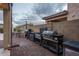 Outdoor kitchen area with built-in grills and dining table, perfect for outdoor entertaining and enjoying backyard gatherings at 9547 W Chama Dr, Peoria, AZ 85383