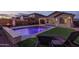 Inviting backyard showcasing a pristine pool, lush green turf, and comfortable lounge chairs, perfect for relaxation and outdoor enjoyment at 9547 W Chama Dr, Peoria, AZ 85383