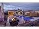 Backyard oasis featuring a sparkling pool, cozy fire pit, and comfortable seating for ultimate outdoor relaxation and entertainment at 9547 W Chama Dr, Peoria, AZ 85383