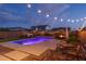 Twilight view of a backyard pool with outdoor seating and ambient string lights at 9547 W Chama Dr, Peoria, AZ 85383