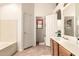 Bathroom with bathtub and vanity; open door leads to water closet with window at 956 N 58Th St, Mesa, AZ 85205