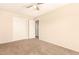 This bedroom offers neutral walls, carpet, ceiling fan, and closet at 956 N 58Th St, Mesa, AZ 85205