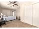 Bedroom features neutral walls, carpet, ceiling fan, and large closets at 956 N 58Th St, Mesa, AZ 85205