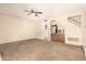 Open living room with a built-in wet bar, neutral carpet, and staircase at 956 N 58Th St, Mesa, AZ 85205