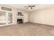 Comfortable living room featuring a fireplace, french doors, neutral carpet, and plenty of natural light at 956 N 58Th St, Mesa, AZ 85205