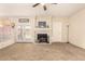 Spacious living room with a fireplace and adjacent dining area with french doors leading to the outdoor space at 956 N 58Th St, Mesa, AZ 85205