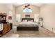 Spacious main bedroom with vaulted ceiling, fan, carpet, and half-moon window at 956 N 58Th St, Mesa, AZ 85205