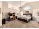 Spacious main bedroom with vaulted ceiling, fan, carpet, and sitting area with desk at 956 N 58Th St, Mesa, AZ 85205