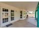 Covered patio with ceiling fan, French doors, and backyard access at 962 E Greenway St, Mesa, AZ 85203