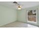 Cozy bedroom featuring neutral-toned walls, a large window, and tile flooring at 962 E Greenway St, Mesa, AZ 85203