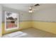 Bright bedroom with tile floors, large window, and ceiling fan at 962 E Greenway St, Mesa, AZ 85203