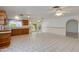 Open-concept kitchen and dining area featuring ample cabinetry, tile flooring, and natural light at 962 E Greenway St, Mesa, AZ 85203