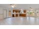 Well-lit kitchen with tile floors, wooden cabinets, and access to outdoor living spaces at 962 E Greenway St, Mesa, AZ 85203