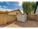 Fenced backyard with gravel, block fence and storage shed at 962 E Greenway St, Mesa, AZ 85203