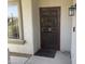 Welcoming front entrance with a secure screen door and a stylish exterior light fixture at 9750 N Monterey Dr # 67, Fountain Hills, AZ 85268