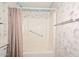 Shower and tub area, featuring an updated shower head and towel bar at 10317 W Desert Forest Cir, Sun City, AZ 85351
