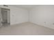 Neutral colored, carpeted bedroom with view to adjacent room at 10317 W Desert Forest Cir, Sun City, AZ 85351