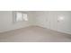 Bright bedroom featuring neutral carpet, window and ample closet space at 10317 W Desert Forest Cir, Sun City, AZ 85351