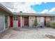 Inviting front entrance with a paved courtyard and a solid wood front door at 10317 W Desert Forest Cir, Sun City, AZ 85351