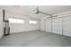 Large garage with epoxy flooring and natural light, providing a functional workspace at 10317 W Desert Forest Cir, Sun City, AZ 85351