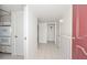 Bright hallway featuring tile flooring and easy access to multiple rooms at 10317 W Desert Forest Cir, Sun City, AZ 85351