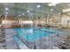 Large indoor pool with ample seating and fitness area, ideal for year-round enjoyment at 10317 W Desert Forest Cir, Sun City, AZ 85351