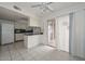 Kitchen features tile flooring, granite countertops, white cabinets, and a ceiling fan at 10317 W Desert Forest Cir, Sun City, AZ 85351