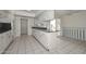 Kitchen featuring white cabinets, tile flooring, granite countertops and breakfast bar at 10317 W Desert Forest Cir, Sun City, AZ 85351