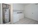 Functional laundry room with washer, storage cabinets, and a utility sink at 10317 W Desert Forest Cir, Sun City, AZ 85351
