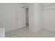 Laundry room featuring tile flooring and built-in shelving at 10317 W Desert Forest Cir, Sun City, AZ 85351