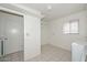 Laundry room featuring tile flooring, and ample storage shelving at 10317 W Desert Forest Cir, Sun City, AZ 85351