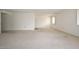 Spacious living room with neutral carpet and an abundance of natural light at 10317 W Desert Forest Cir, Sun City, AZ 85351