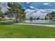 A beautiful community pond with a manicured lawn at 10317 W Desert Forest Cir, Sun City, AZ 85351