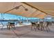 Shaded outdoor tennis courts with tables and chairs at 10317 W Desert Forest Cir, Sun City, AZ 85351