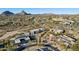 Expansive aerial view of a luxurious neighborhood with golf course and mountain backdrop at 10801 E Happy Valley Rd # 86, Scottsdale, AZ 85255