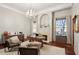 This home office offers a fireplace, chandelier, and hardwood floors at 10801 E Happy Valley Rd # 86, Scottsdale, AZ 85255